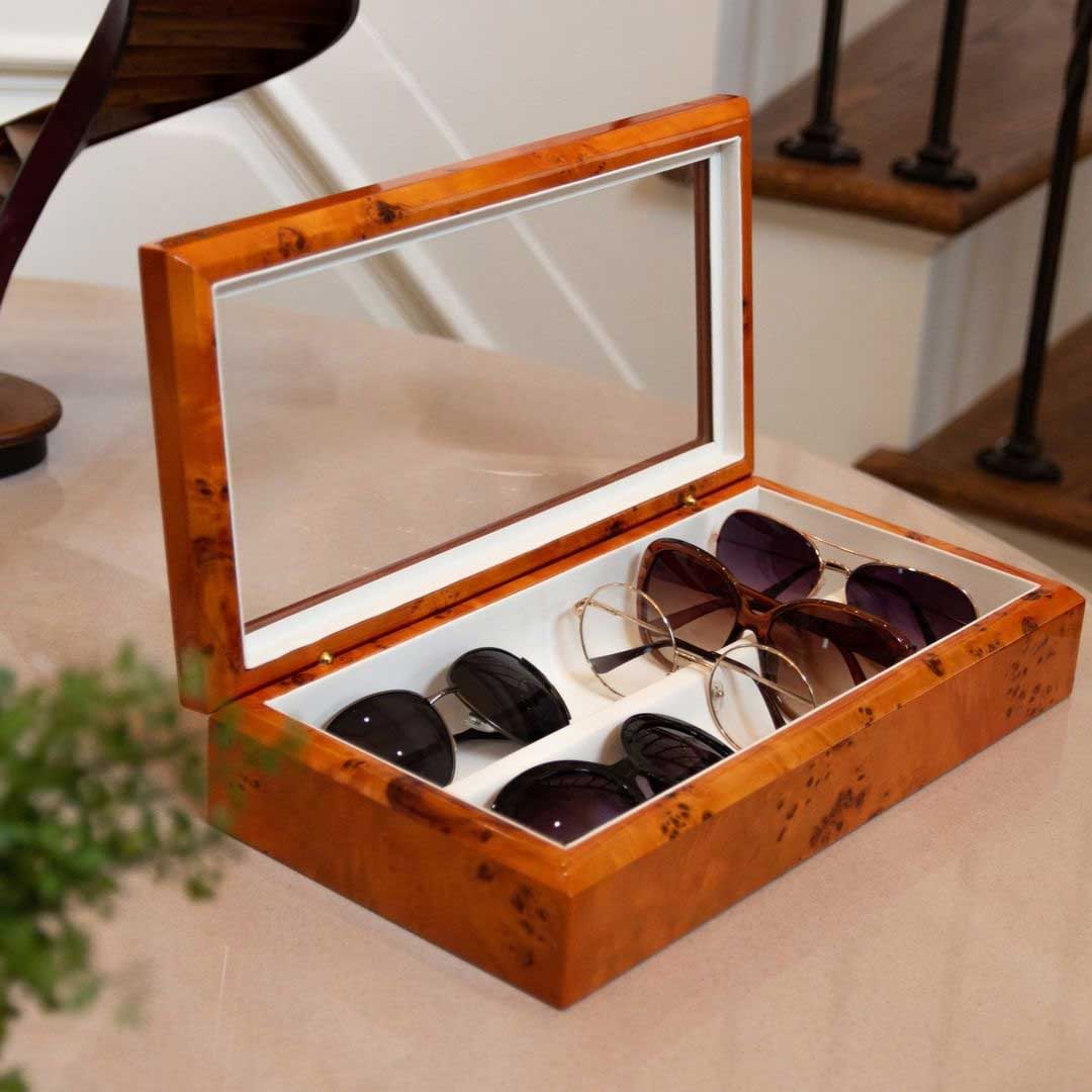 gift shop -gift shop Wood sunglasses box with glass lid lying on beige table top